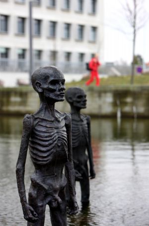 The picture taken on Dec. 8, 2009, shows models of supposed refugees come into being by climate change erected in water outside the conference center of the 3rd Annual Climate Change Summit in Copenhagen, Demark. UN&apos;s climate panel expects 200 million climate refugees before 2050. [Xie Xiudong/Xinhua]