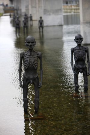 The picture taken on Dec. 8, 2009, shows models of supposed refugees come into being by climate change erected in water outside the conference center of the 3rd Annual Climate Change Summit in Copenhagen, Demark. UN&apos;s climate panel expects 200 million climate refugees before 2050. [Xie Xiudong/Xinhua]