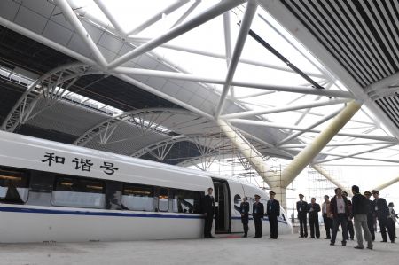 The test-running train prepares for its first journey at the station in Guangzhou, capital of south China&apos;s Guangdong Province, Dec. 9, 2009.[Lu Hanxin/Xinhua] 