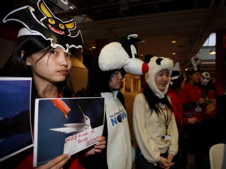 Members of China Youth Delegation are dressed up to represent the endangered animals during an activity promoting environmental protection, at Bella Center, the venue of the United Nations Climate Change Conference, in Copenhagen, Denmark, Dec. 9, 2009.