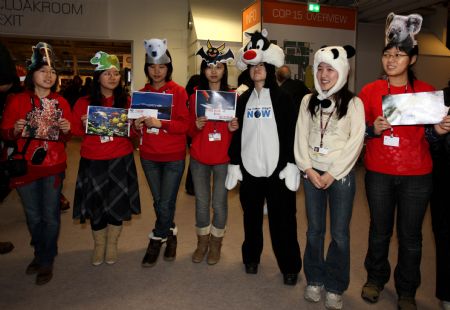 Members of China Youth Delegation are dressed up to represent the endangered animals during an activity promoting environmental protection, at Bella Center, the venue of the United Nations Climate Change Conference, in Copenhagen, Denmark, Dec. 9, 2009. 