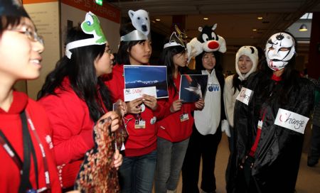 Members of China Youth Delegation are dressed up to represent the endangered animals and the devil (R1) during an activity promoting environmental protection, at Bella Center, the venue of the United Nations Climate Change Conference, in Copenhagen, Denmark, Dec. 9, 2009. 