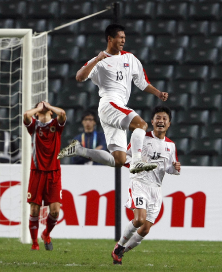 North Korea&apos;s Pak Kwang-ryong (13) celebrates after scoring.a goal against Hong Kong during their men&apos;s soccer semifinal match at the East Asian Games in Hong Kong December 10, 2009. [China Daily/Agencies] 