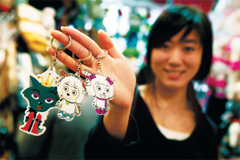  An assistant in a Beijing shopping center displays keychains with images from the popular cartoon series 'Pleasant Goat and Big, Big Wolf.'