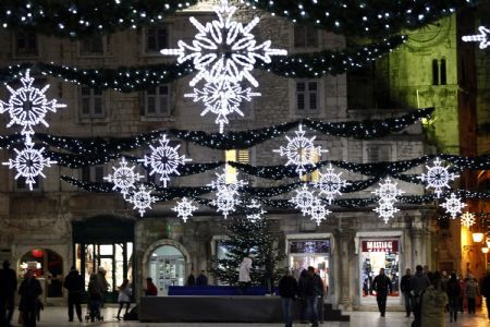 People walk past Christmas lights in the Adriatic City of Split, December 12,2009.