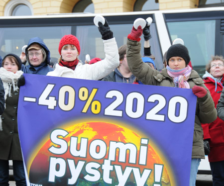 Finnish people hold banners and ring alarms during a protest to demand developed countries&apos; greenhouse gas emission reduction in Helsinki, Dec. 12, 2009. People in 12 different cities in Finland protested on Saturday against developed countries&apos; greenhouse gas emission and demand the reduction by 40 percents in 2020 compared with the emission volume of the year 1990 as well as an annual 110-billion-euro aide for developing countries.
