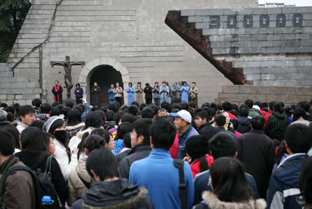 Performers present drama &apos;Occupation&apos; on the square in front of the Memorial Hall of the Victims in the Nanjing Massacre, marking the 72nd anniversary of the tragedy, in Nanjing, capital of east China&apos;s Jiangsu Province, Dec. 13, 2009. Japanese troops occupied Nanjing on Dec. 13, 1937, and launched a six-week massacre. Chinese records show more than 300,000 people, not only disarmed soldiers but also civilians, were killed. [Wang Xin/Xinhua]
