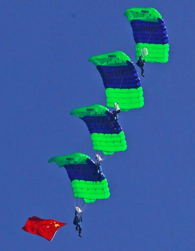 Members of the Bayi (Aug. 1) Parachute Jumping Team of the Air Force of the Chinese People's Liberation Army (PLA) perform to celebrate the 10th anniversary of Macao's return to China, in Macao, south China, Dec. 13, 2009. [Tan Chao/Xinhua]