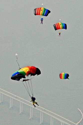 Members of the Bayi (Aug. 1) Parachute Jumping Team of the Air Force of the Chinese People's Liberation Army (PLA) perform to celebrate the 10th anniversary of Macao's return to China, in Macao, south China, Dec. 13, 2009. [Tan Chao/Xinhua]
