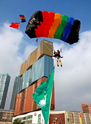 Members of the Bayi (Aug. 1) Parachute Jumping Team of the Air Force of the Chinese People's Liberation Army (PLA) perform to celebrate the 10th anniversary of Macao's return to China, in Macao, south China, Dec. 13, 2009. [Tan Chao/Xinhua]