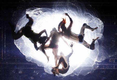 Dancers perform on a watery stage suspended above the audience during the Argentinian show Fuerza Bruta (Brute Force) in New York, Dec. 13, 2009. [Xinhua/Reuters] 