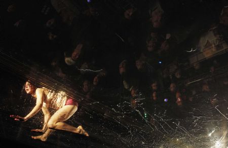 Dancers perform on a watery stage suspended above the audience during the Argentinian show Fuerza Bruta (Brute Force) in New York, Dec. 13, 2009. [Xinhua/Reuters] 