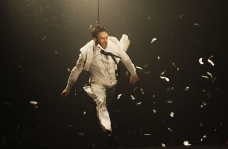 A dancer performs on a watery stage suspended above the audience during the Argentinian show Fuerza Bruta (Brute Force) in New York, Dec. 13, 2009.[Xinhua/Reuters]