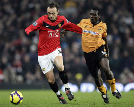 Manchester United&apos;s Dimitar Berbatov (L) holds off Wolverhampton Wanderers&apos; Segundo Castillo during their English Premier League soccer match at Old Trafford in Manchester, northern England, December 15, 2009. [Xinhua/Reuters]