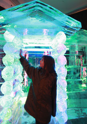 A girl touches an ice sculpture as she visits the China Ice Sculpture Art Festival in Berlin, capital of Germany, Dec. 15, 2009. The China Ice Sculpture Art Festival runs from Nov. 27, 2009 to Feb. 19, 2010. (Xinhua/Luo Huanhuan)
