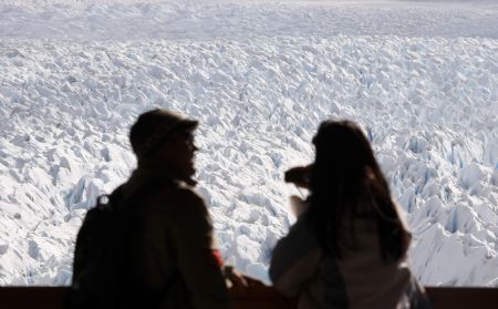 A couple looks at the Perito Moreno glacier from a balcony near the city of El Calafate, in the Patagonian province of Santa Cruz, December 14, 2009.