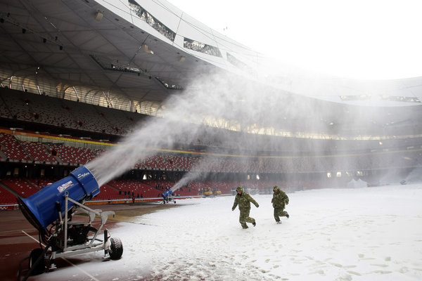 Workers shovel artificial snow inside China&apos;s iconic national stadium, also known as the Bird&apos;s Nest on Dec. 13, 2009 in Beijing. The stadium has been turned into a winter playground at a cost of around 50 million yuan (US$7 million) in an effort to attract more tourists during the quieter Christmas and Chinese New Year season. [CFP]