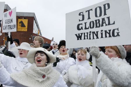 Protestors hold signboards during a demonstration in Copenhagen December 16, 2009. Copenhagen is the host city for the United Nations Climate Change Conference 2009, which lasts from December 7 until December 18.[Xinhua/Reuters]