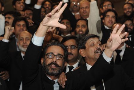 Pakistani lawyers shout slogans in support of Chief Justice Iftikhar Mohammad Chaudhry outside the Supreme Court in Islamabad. [Xinhua/AFP]