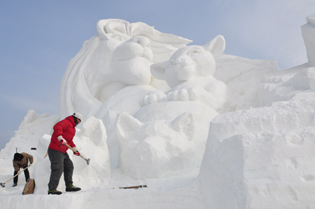 Two snow sculptors work on snow carvings at the Jiangxindao Snow Castle in Mudanjiang City of northeast China&apos;s Heilongjiang Province, Dec. 16, 2009. Covering an area of 63, 000 square meters, the Mudanjiang Snow Castle with the theme of &apos;Fairy Tales in the Snow World&apos; will open to the public on Dec. 18. [Xinhua]