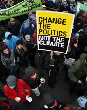Protestors hold signs as they march towards the Bella Center, where the UN Climate Change 2009 Conference is taking place, during a demonstration in Copenhagen December 16, 2009. 
