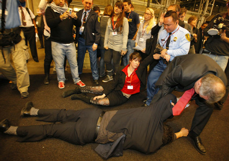 Activists are evacuated by security from the plenary hall of the Bella Center during a sit-in demonstration, Copenhagen, Dec. 16,2009