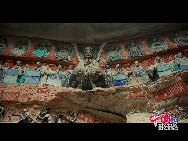 The Dazu Rock Carvings are a series of Chinese religious sculptures and carvings, dating back as far as the 7th century A.D., depicting and influenced by Buddhist, Confucian and Taoist beliefs. Listed as a World Heritage Site, the Dazu Rock Carvings are made up of 75 protected sites containing some 50,000 statues, with over 100,000 Chinese characters forming inscriptions and epigraphs. The sites are located in Chongqing Municipality within the steep hillsides throughout Dazu County. [Photo by Wu Changqing] 