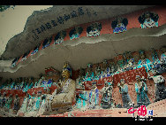 The Dazu Rock Carvings are a series of Chinese religious sculptures and carvings, dating back as far as the 7th century A.D., depicting and influenced by Buddhist, Confucian and Taoist beliefs. Listed as a World Heritage Site, the Dazu Rock Carvings are made up of 75 protected sites containing some 50,000 statues, with over 100,000 Chinese characters forming inscriptions and epigraphs. The sites are located in Chongqing Municipality within the steep hillsides throughout Dazu County. [Photo by Wu Changqing] 