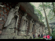 The Dazu Rock Carvings are a series of Chinese religious sculptures and carvings, dating back as far as the 7th century A.D., depicting and influenced by Buddhist, Confucian and Taoist beliefs. Listed as a World Heritage Site, the Dazu Rock Carvings are made up of 75 protected sites containing some 50,000 statues, with over 100,000 Chinese characters forming inscriptions and epigraphs. The sites are located in Chongqing Municipality within the steep hillsides throughout Dazu County. [Photo by Wu Changqing] 