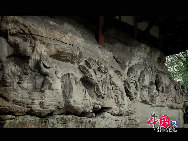 The Dazu Rock Carvings are a series of Chinese religious sculptures and carvings, dating back as far as the 7th century A.D., depicting and influenced by Buddhist, Confucian and Taoist beliefs. Listed as a World Heritage Site, the Dazu Rock Carvings are made up of 75 protected sites containing some 50,000 statues, with over 100,000 Chinese characters forming inscriptions and epigraphs. The sites are located in Chongqing Municipality within the steep hillsides throughout Dazu County. [Photo by Wu Changqing] 