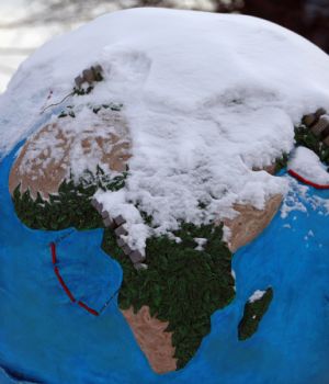 A globe is seen partially covered by snow in Copenhagen December 17, 2009. Copenhagen is the host city for the United Nations Climate Change Conference 2009, which lasts from December 7 until December 18.