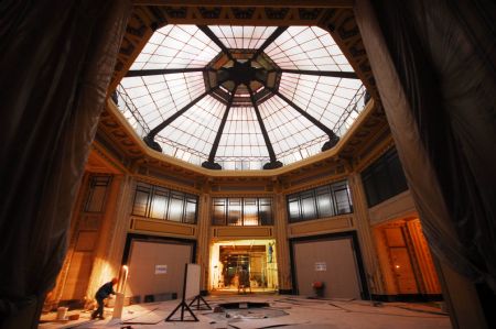 A construction worker works at the Octagonal Hall of the Shanghai Peace Hotel in Shanghai, the economic and financial hub of China, Dec. 17, 2009.