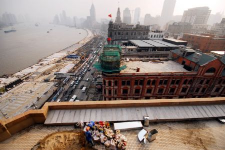 A construction worker makes preparations at the roof of the Shanghai Peace Hotel in Shanghai, the economic and financial hub of China, Dec. 17, 2009.