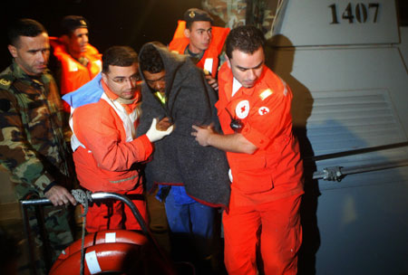 A Lebanese soldier and rescue workers help a survivor of a sunken Panama ship after he was rescued off the port of Tripoli in northern Lebanon, December 17, 2009. Dozens of people were missing on Thursday after a ship carrying livestock sank in the Mediterranean off Lebanon in stormy weather, Lebanese naval sources said.