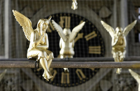 Golden angels attached at scaffolding are pictured during an exhibition in the Holy Cross church in Munich December 17, 2009. The installation known as &apos;Guardian angel over Munich&apos; by German artist Ottmar Hoerl runs until February 2, 2010. 