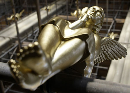 One of 300 golden angels is pictured attached at scaffolding during an exhibition in the Holy Cross church in Munich December 17, 2009. The installation known as &apos;Guardian angel over Munich&apos; by German artist Ottmar Hoerl runs until February 2, 2010. 