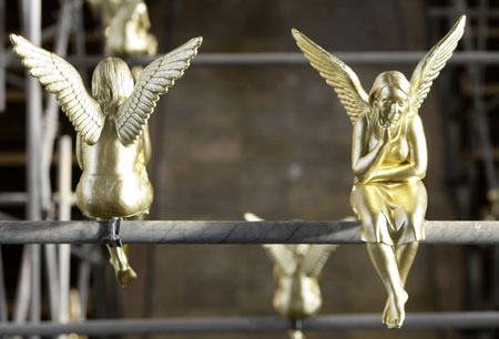 Golden angels attached at scaffolding are pictured during an exhibition in the Holy Cross church in Munich December 17, 2009. The installation known as &apos;Guardian angel over Munich&apos; by German artist Ottmar Hoerl runs until February 2, 2010. 