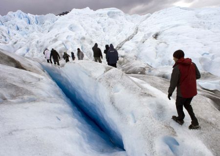 Climbers trek next to a crack on Argentina&apos;s Perito Moreno glacier near the city of El Calafate, in the Patagonian province of Santa Cruz, December 16, 2009.