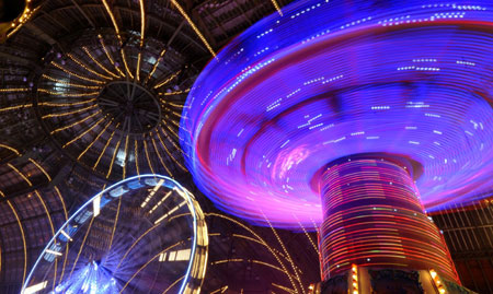 A merry-go-round turns at a funfair inside Paris&apos; Grand Palais as part of holiday activities in the French capital December 17, 2009. The fair opens on December 18 and will run until January 1.