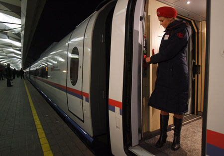An attendant waits for passengers aboard high speed train Sapsan in Moscow, December 17, 2009. Sapsan will take passengers from Moscow to St. Petersburg in 3 hours and 45 minutes at a top speed of 250 kmph (155 miles per hour). 