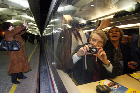 A passenger takes a picture as he sits aboard high speed train Sapsan in Moscow, December 17, 2009. Sapsan will take passengers from Moscow to St. Petersburg in 3 hours and 45 minutes at a top speed of 250 kmph (155 miles per hour). 
