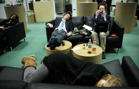 People rest on the couches at the Bella Center during the United Nations Climate Change Conference in Copenhagen, capital of Denmark, Dec. 19, 2009.