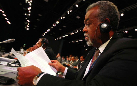 Delegates read papers with 'The Copenhagen Accord' during a night plenary meeting at the United Nations Climate Change Conference (COP15) at the Bella Center in Copenhagen, December 19, 2009. The UN climate change conference failed to adopt the Copenhagen Accord on Dec. 19.