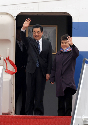 Chinese President Hu Jintao(L) waves upon his arrival at Macao International Airport in Macao Special Administrative Region (SAR) in south China Dec. 19, 2009. (Xinhua/Lui Siu Wai)