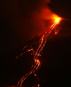 Glowing lava cascades down the slopes of the Mayo vocalno in Albay province, the Philippines, on Dec. 20, 2009. The possibility of hazardous volcanic eruption is high, the government warned as it called for the evacuation of residents living near the foot of the restive Mayon Volcano. Relief officials said more than 40,000 people have already moved to 25 evacuation centers in eight municipalities around Mayon. [Xinhua]