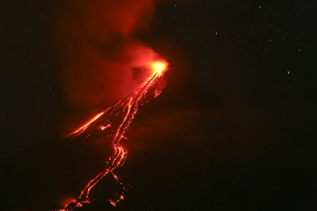 Glowing lava cascades down the slopes of the Mayo vocalno in Albay province, the Philippines, on Dec. 20, 2009. The possibility of hazardous volcanic eruption is high, the government warned as it called for the evacuation of residents living near the foot of the restive Mayon Volcano. Relief officials said more than 40,000 people have already moved to 25 evacuation centers in eight municipalities around Mayon. [Xinhua]