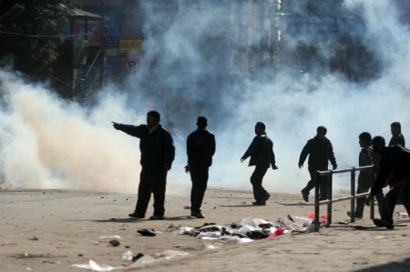 Supporters of the Unified Communist Party of Nepal (Maoist) (UCPN-M) throw stones to the police during a clash in Kathmandu, capital of Nepal, Dec. 20, 2009. Members of the UCPN-M and their supporters Sunday engaged in violent clashes with riot police, on the first day of the UCPN-M&apos;s three-day nationwide strike. (Xinhua/Bimal Gautam)