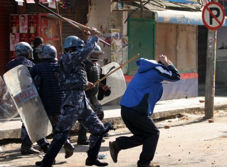 Nepalese police baton a demonstrator during a clash in Kathmandu, capital of Nepal, Dec. 20, 2009. Members of the Unified Communist Party of Nepal (Maoist) (UCPN-M) and their supporters Sunday engaged in violent clashes with riot police, on the first day of the UCPN-M&apos;s three-day nationwide strike. (Xinhua/Bimal Gautam) 