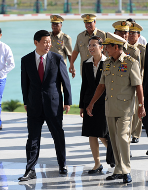 Visiting Chinese Vice President Xi Jinping (L front) and Maung Aye, vice-chairman of Myanmar&apos;s State Peace and Development Council, enter the venue of their talks in Nay Pyi Taw, Myanmar, Dec. 20, 2009.(Xinhua/Ma Zhancheng