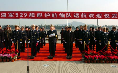 A welcoming ceremony is held in honour of "Zhoushan" and "Xuzhou" warships upon their return to their home port in Zhoushan, Zhejiang Province, Dec. 20, 2009. The domestically-made "Zhoushan" and "Xuzhou" warships returned to their home port in Zhoushan on Sunday after an escort mission against pirates in the Gulf of Aden. According to the commander of the Chinese naval 3rd escort fleet Wang Zhiguo, the flotilla has undertaken 53 batches of escort mission involving 582 vessels since August 1, 2009. (Xinhua/Guo Gang)